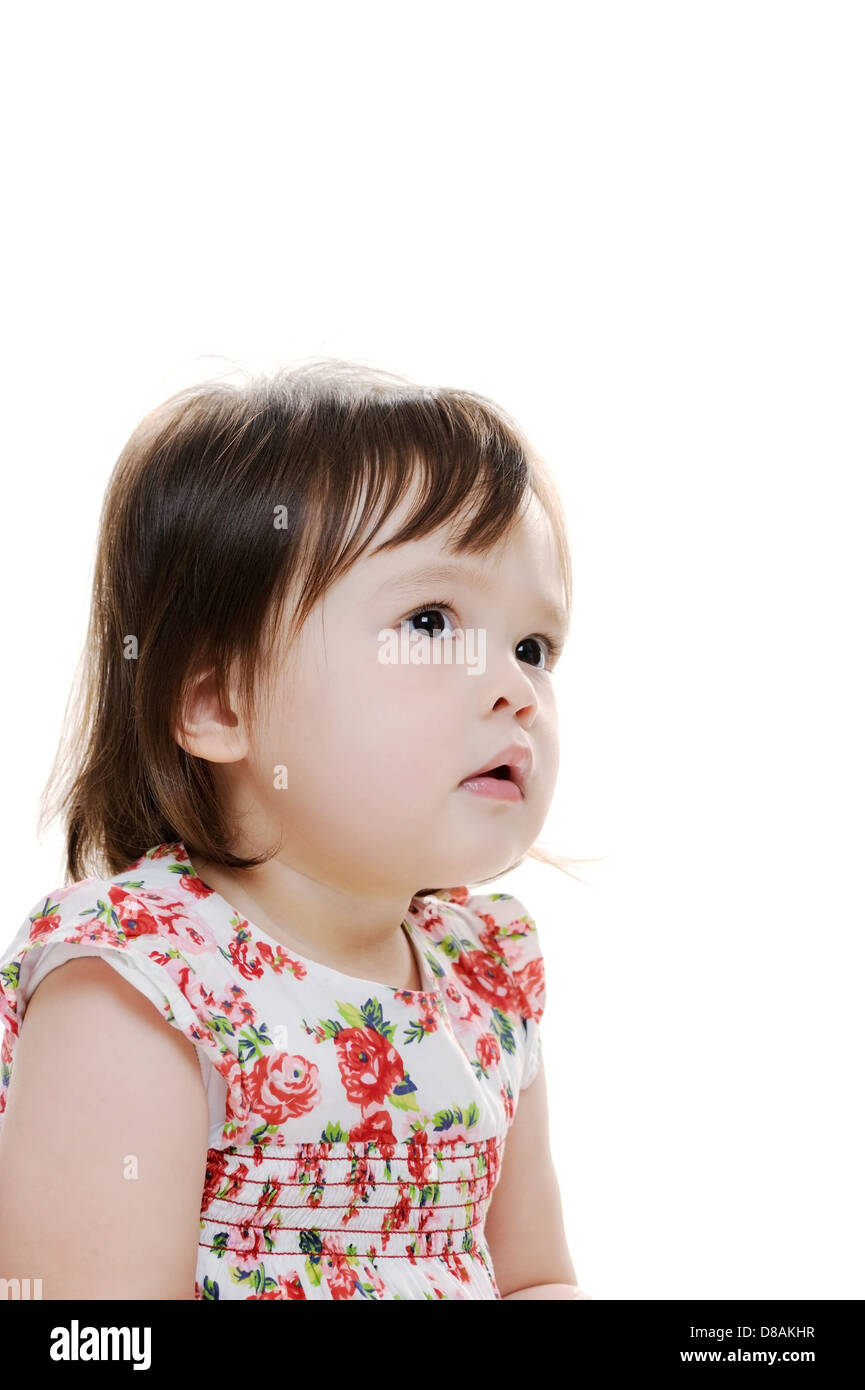 Perplexed young infant girl looking up Stock Photo