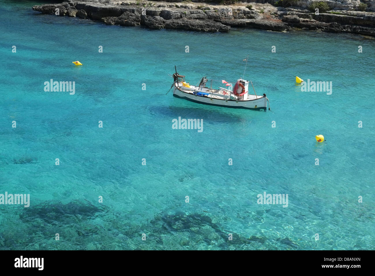 Menorcan fishing boat (llaut) 'Dos Germans' on mooring in blue water at