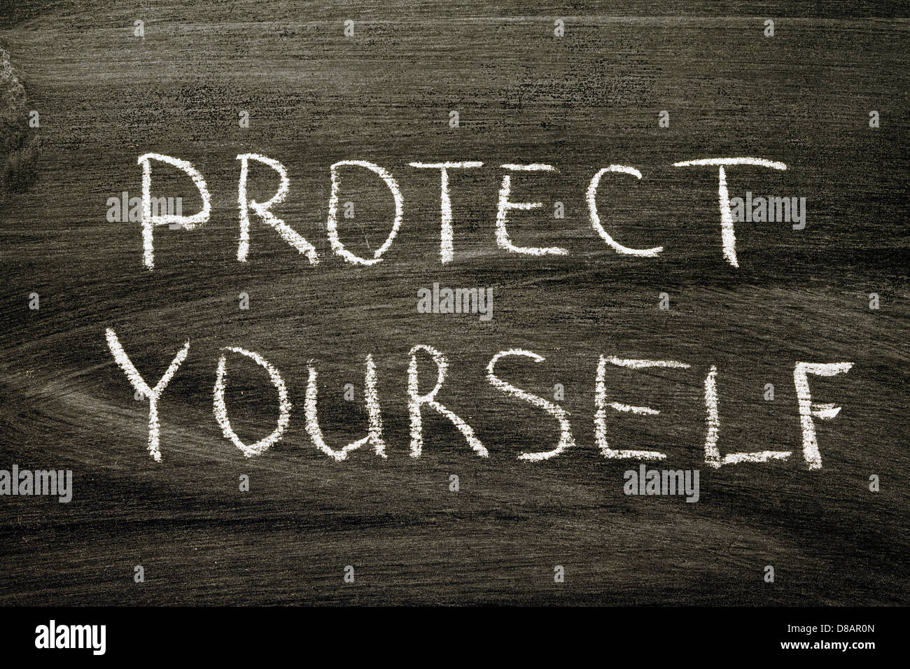 protect yourself phrase handwritten on school blackboard Stock Photo