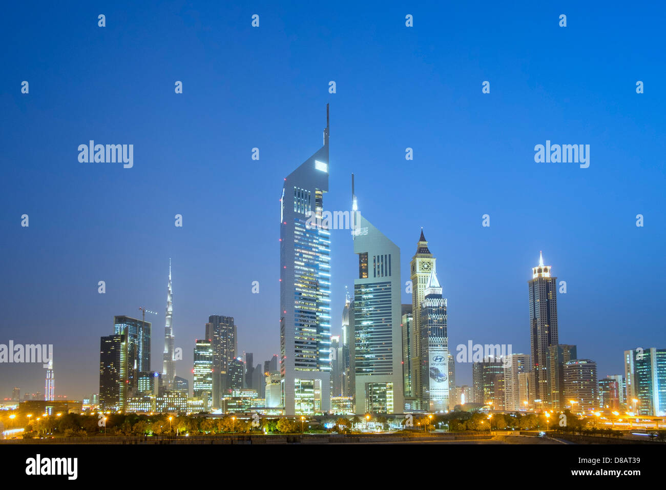 Night skyline view of Emirates Towers and the financial district in Dubai United Arab Emirates Stock Photo