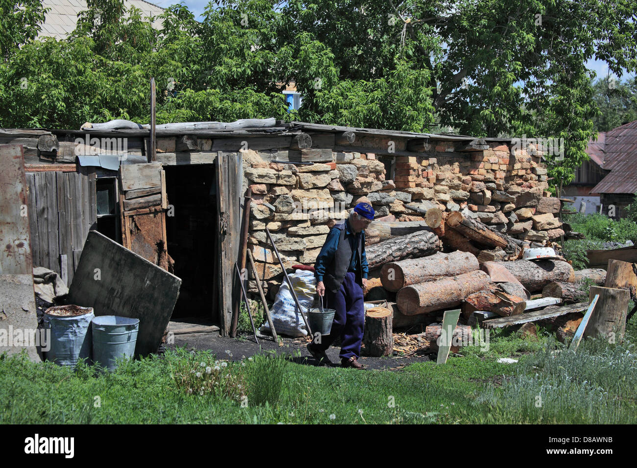 Rural life - old man, kazakh go from shed to his house Stock Photo
