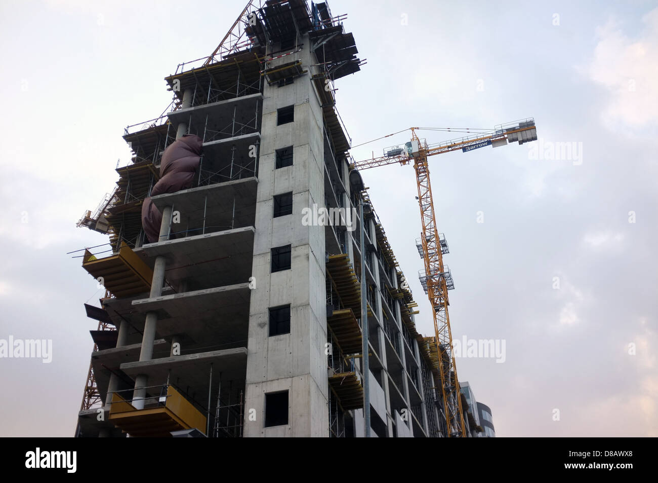 A tall crane towers over a office building under construction in Johannesburg, South Africa. Stock Photo