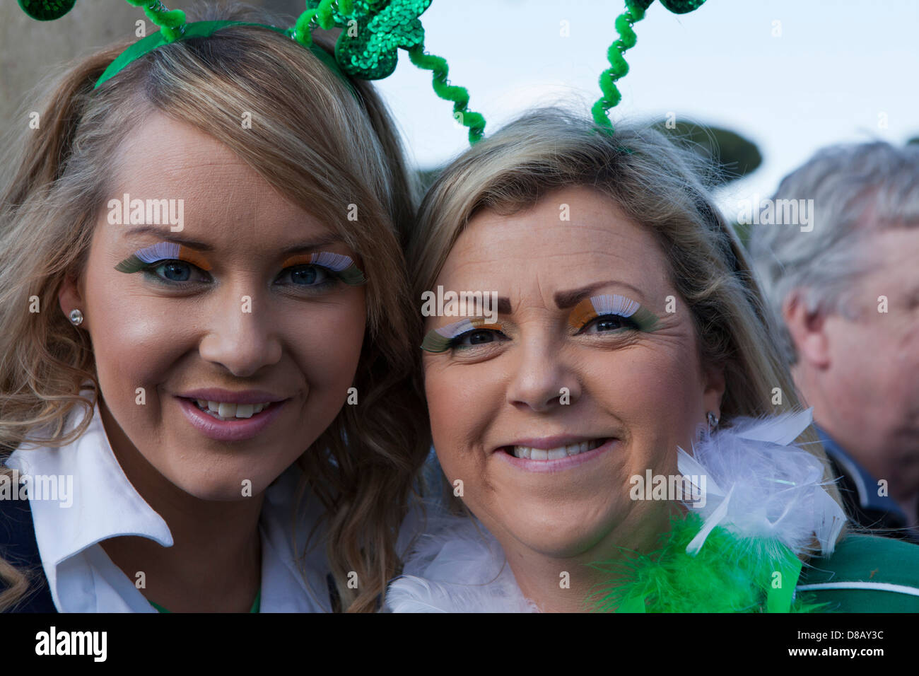 Two girls twenties supporting Ireland rugby team in Rome with painted eyelashes Stock Photo