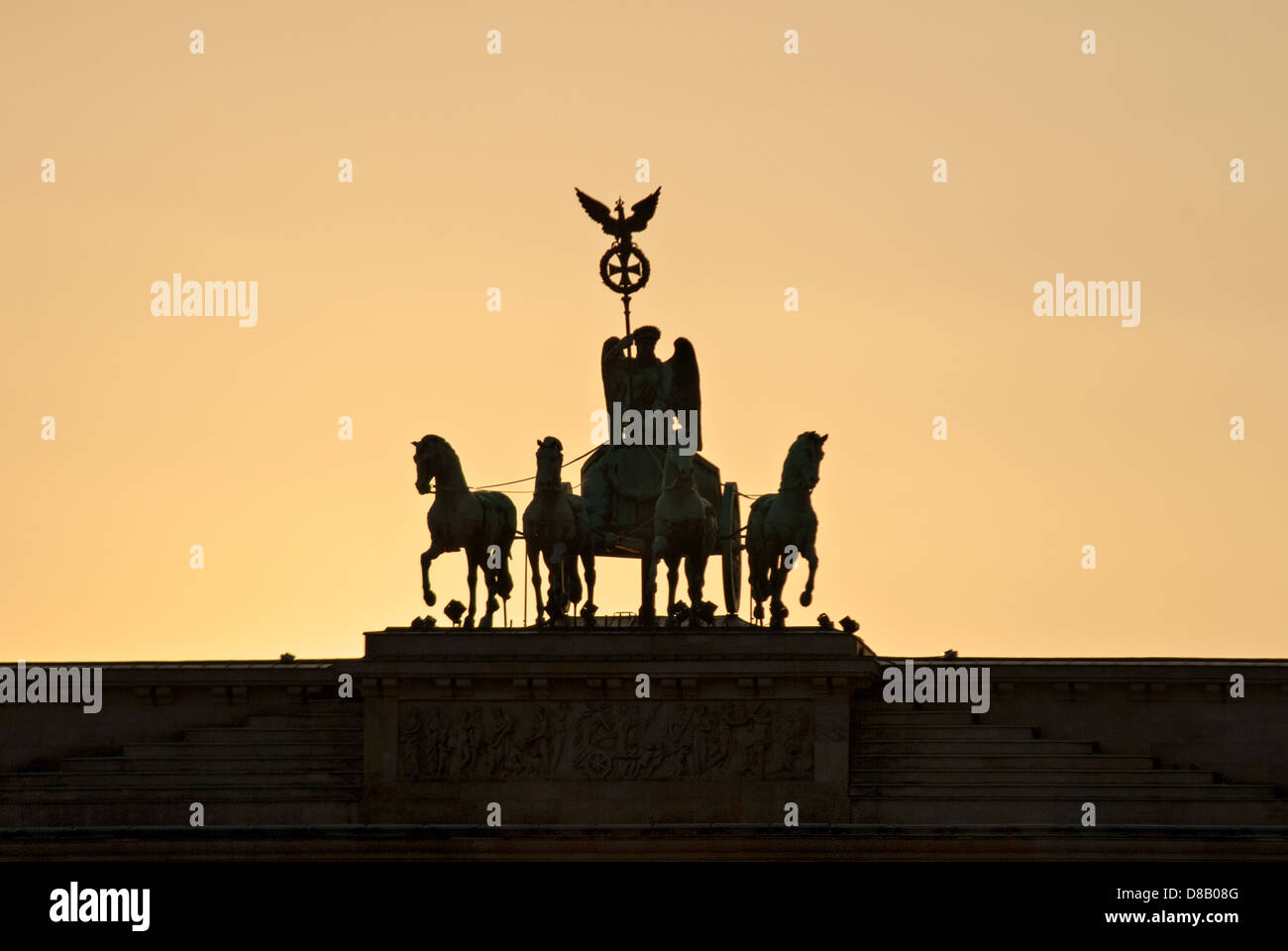 The Berlin Quadriga designed by Johann Gottfried Schadow atop the Brandenburg Gate at sunset Berlin Germany Stock Photo