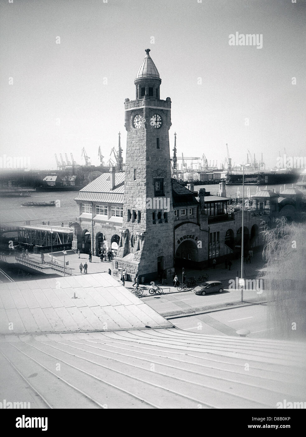 Pegelturm (gauge tower) of Sankt Pauli Landungsbrücken with Blohm+Voss shipyard at the back in the port of Hamburg. Stock Photo