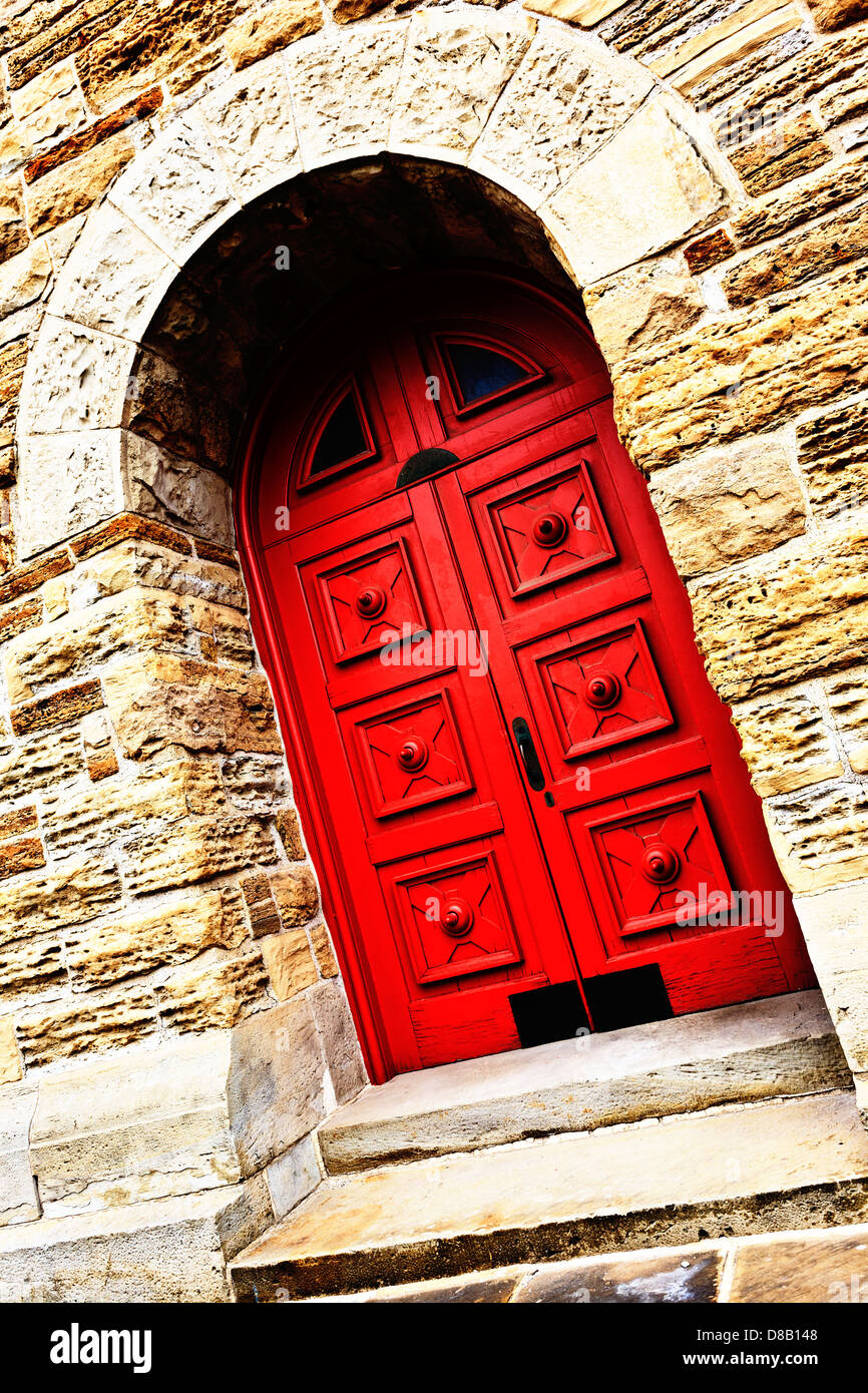 Red door in stone building Stock Photo