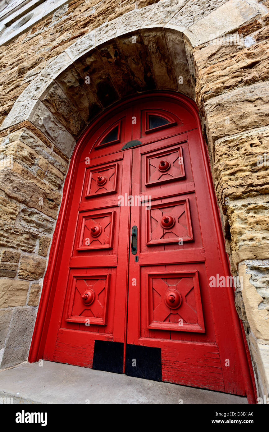 Red door in stone building Stock Photo