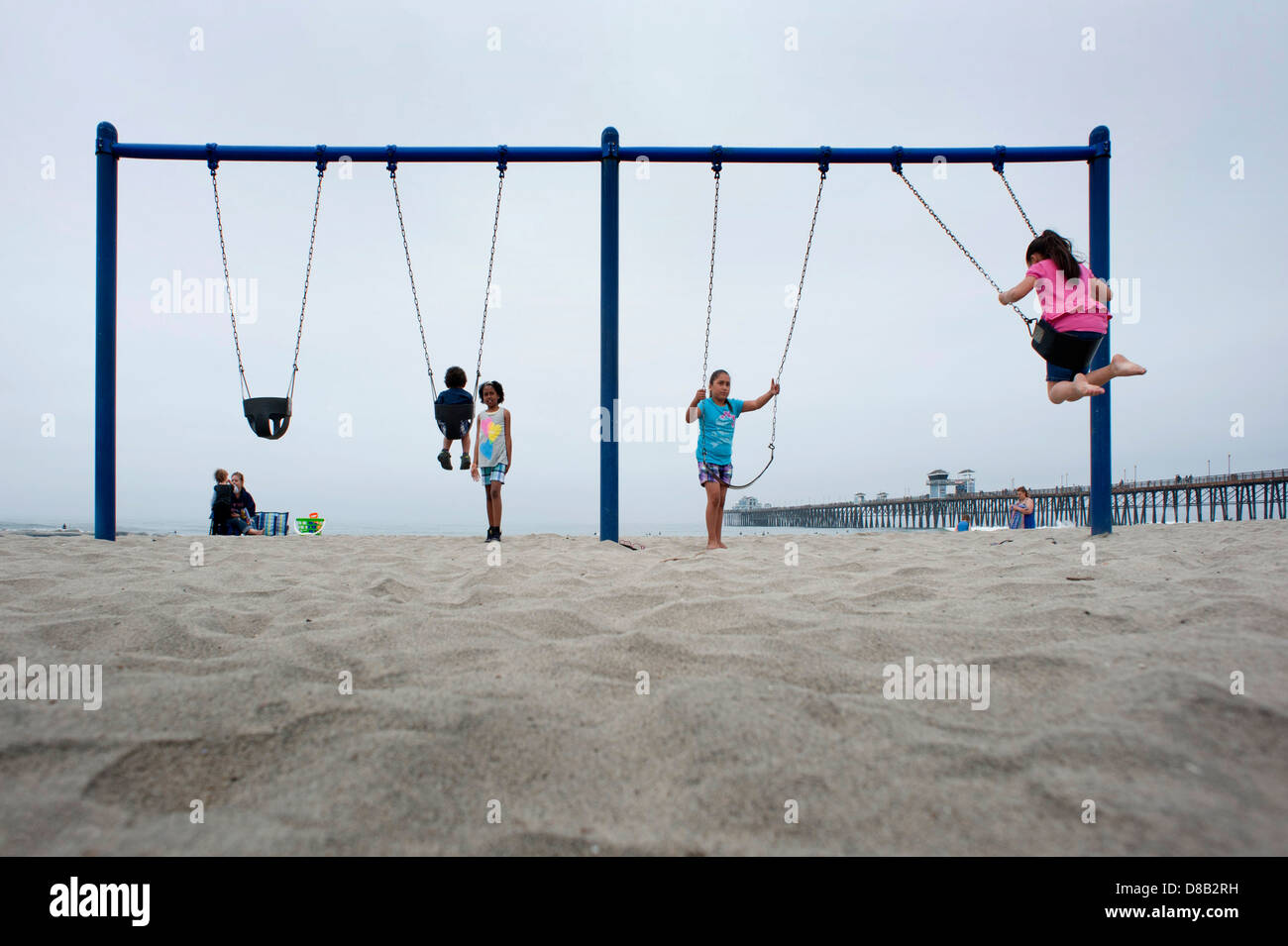 Children playing on swings on the beach at Oceanside, California Stock Photo Alamy