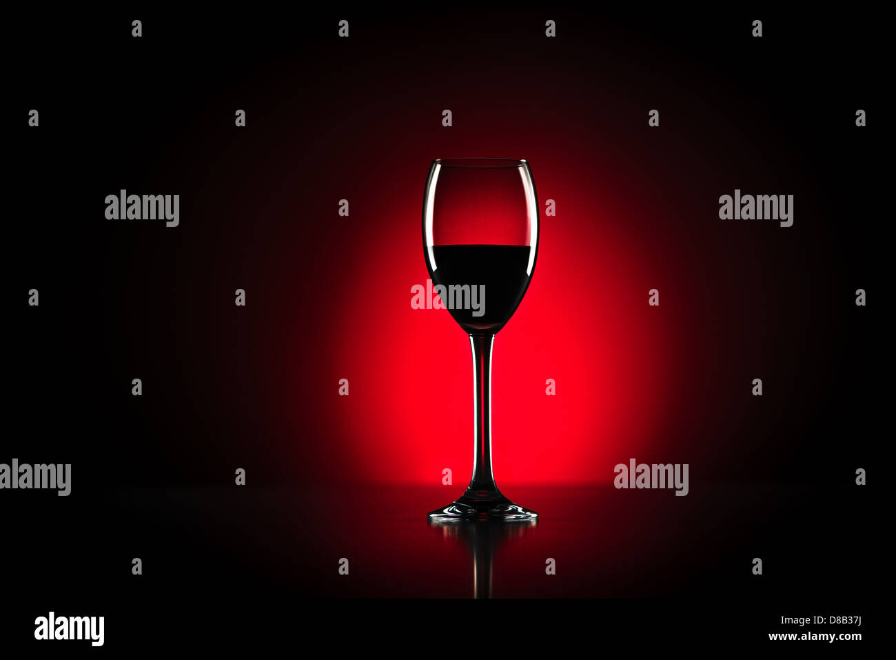 Red wine glass in studio with red background Stock Photo Alamy