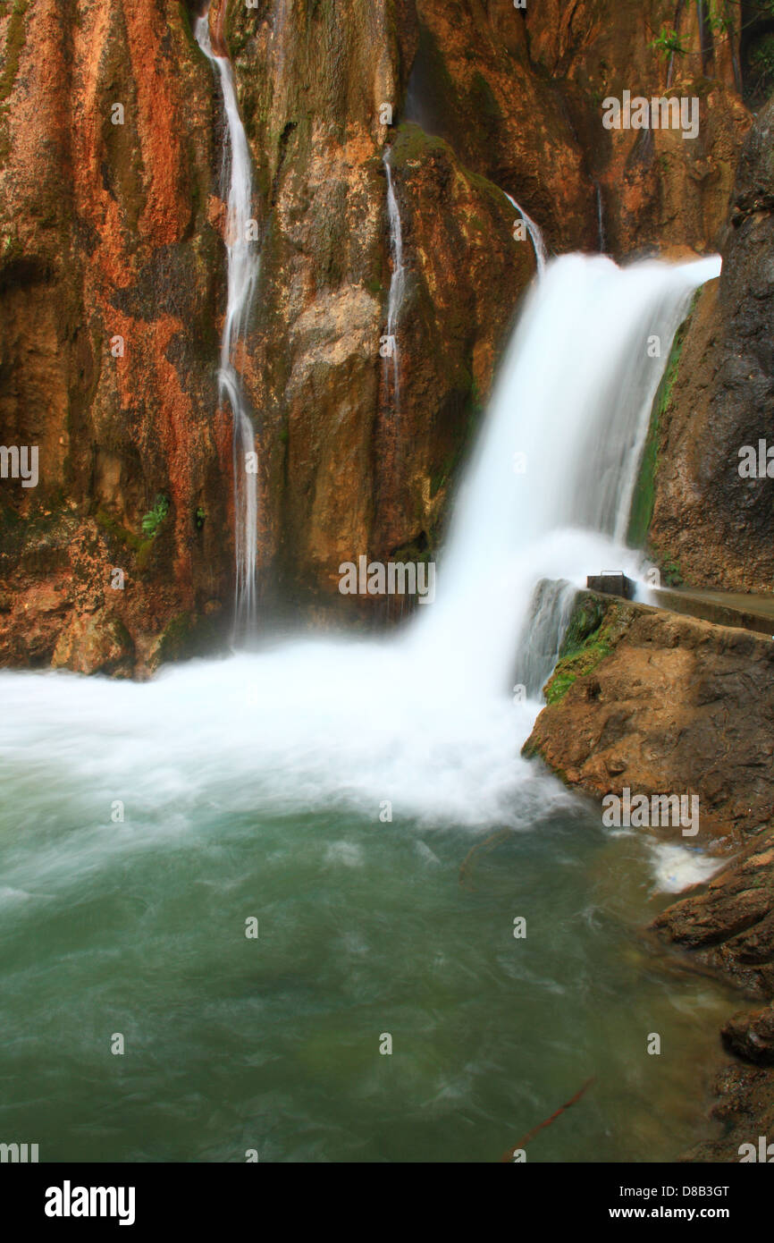 water falling to river between huge rocks  Stock Photo