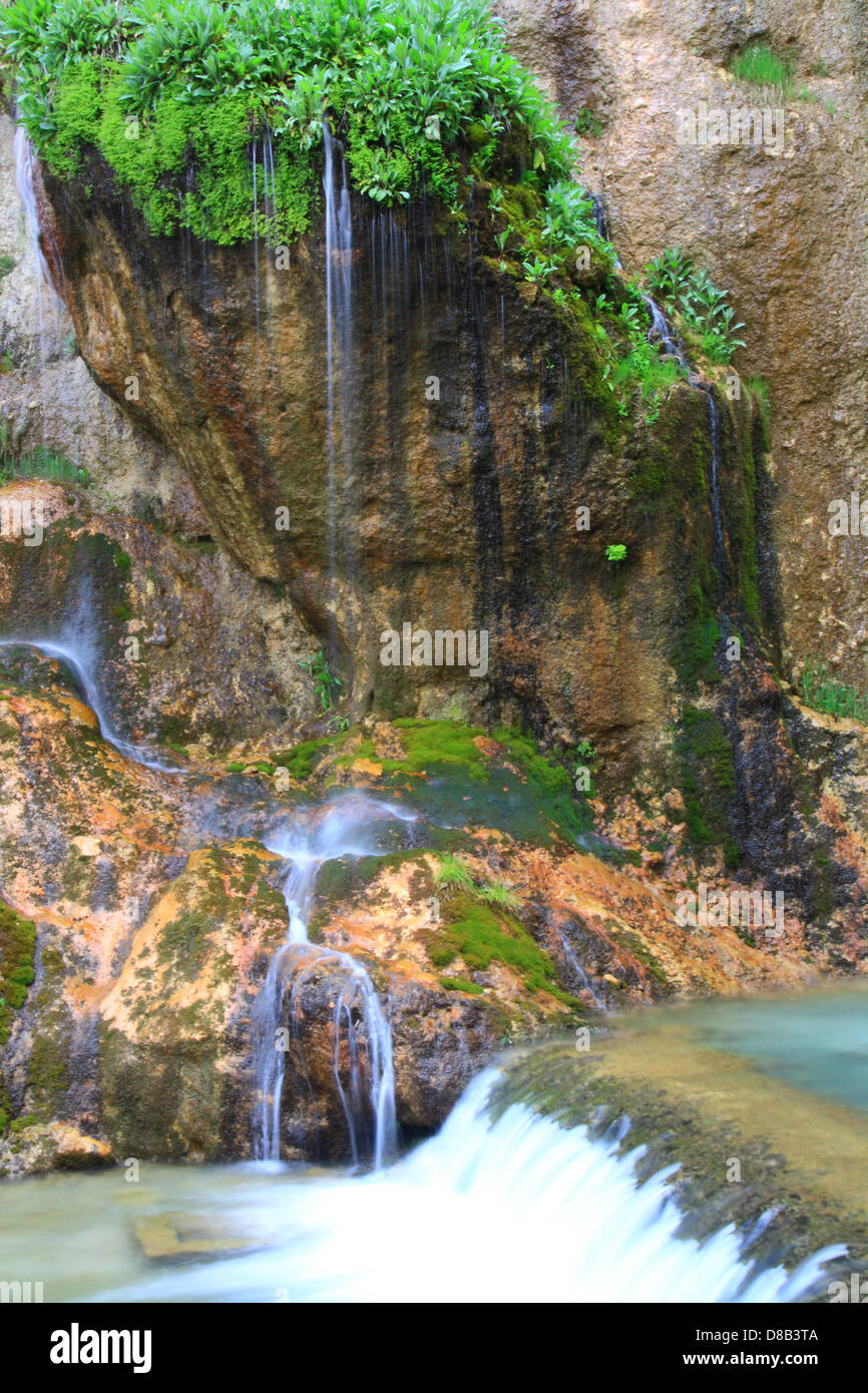 water falling to river between huge rocks  Stock Photo