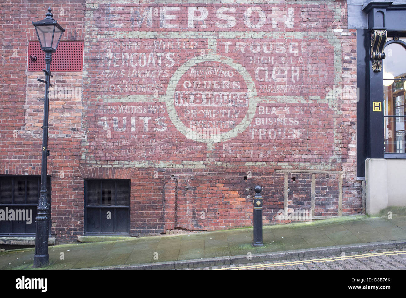 The painted wall of an old shop front in Stockport town centre. Stock Photo