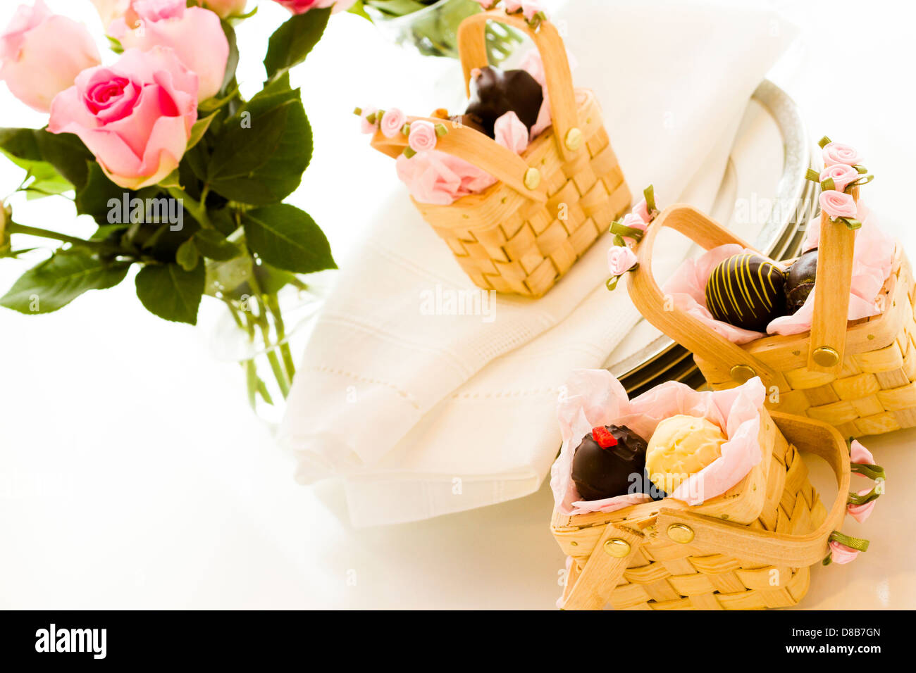 Miniature picnic baskets favor boxes filled with truffles Stock Photo