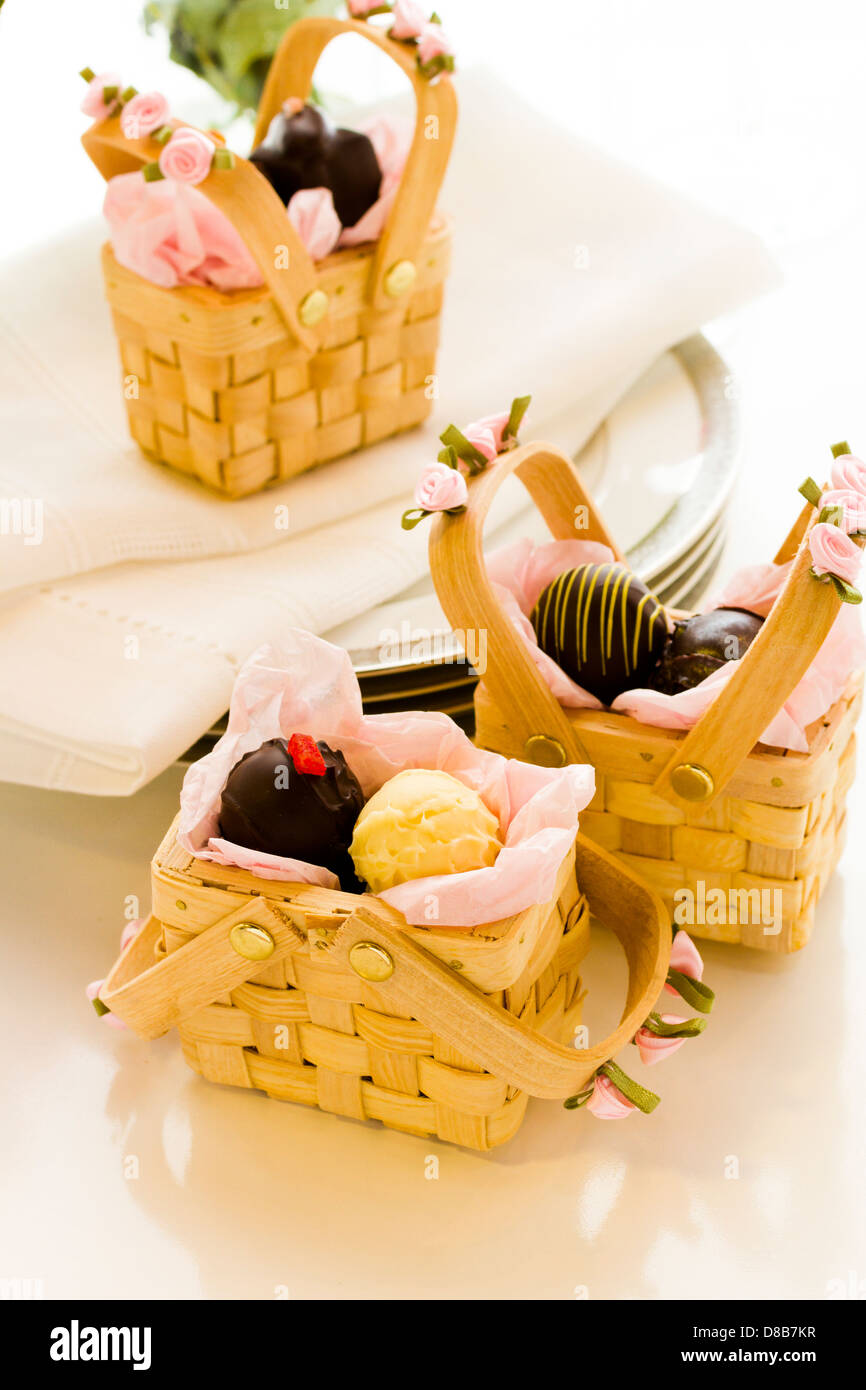 Miniature picnic baskets favor boxes filled with truffles Stock Photo