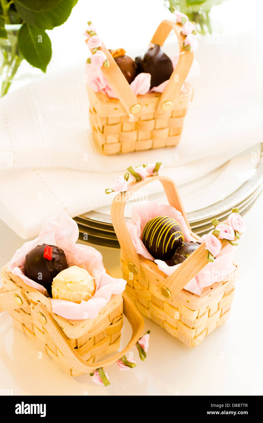 Miniature picnic baskets favor boxes filled with truffles Stock Photo