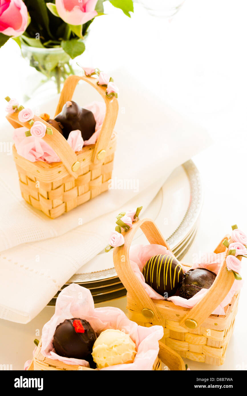 Miniature picnic baskets favor boxes filled with truffles Stock Photo