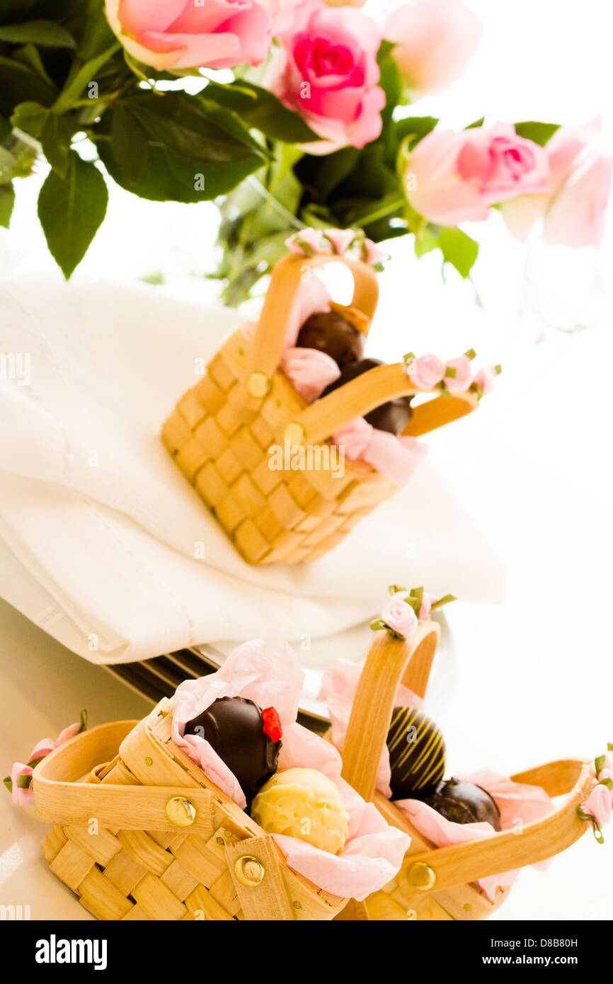 Miniature picnic baskets favor boxes filled with truffles Stock Photo