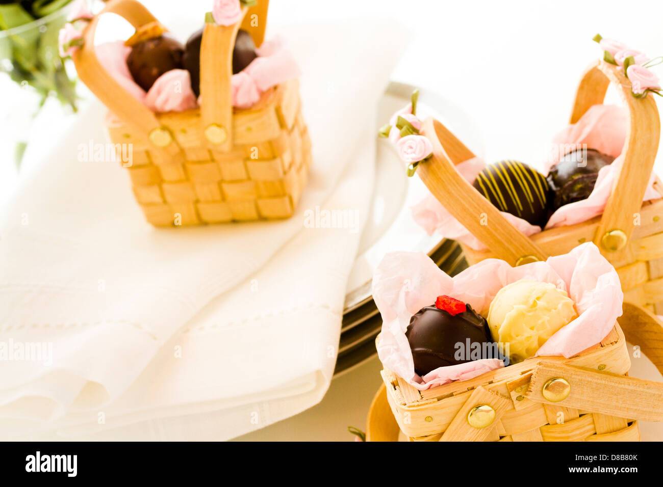 Miniature picnic baskets favor boxes filled with truffles Stock Photo
