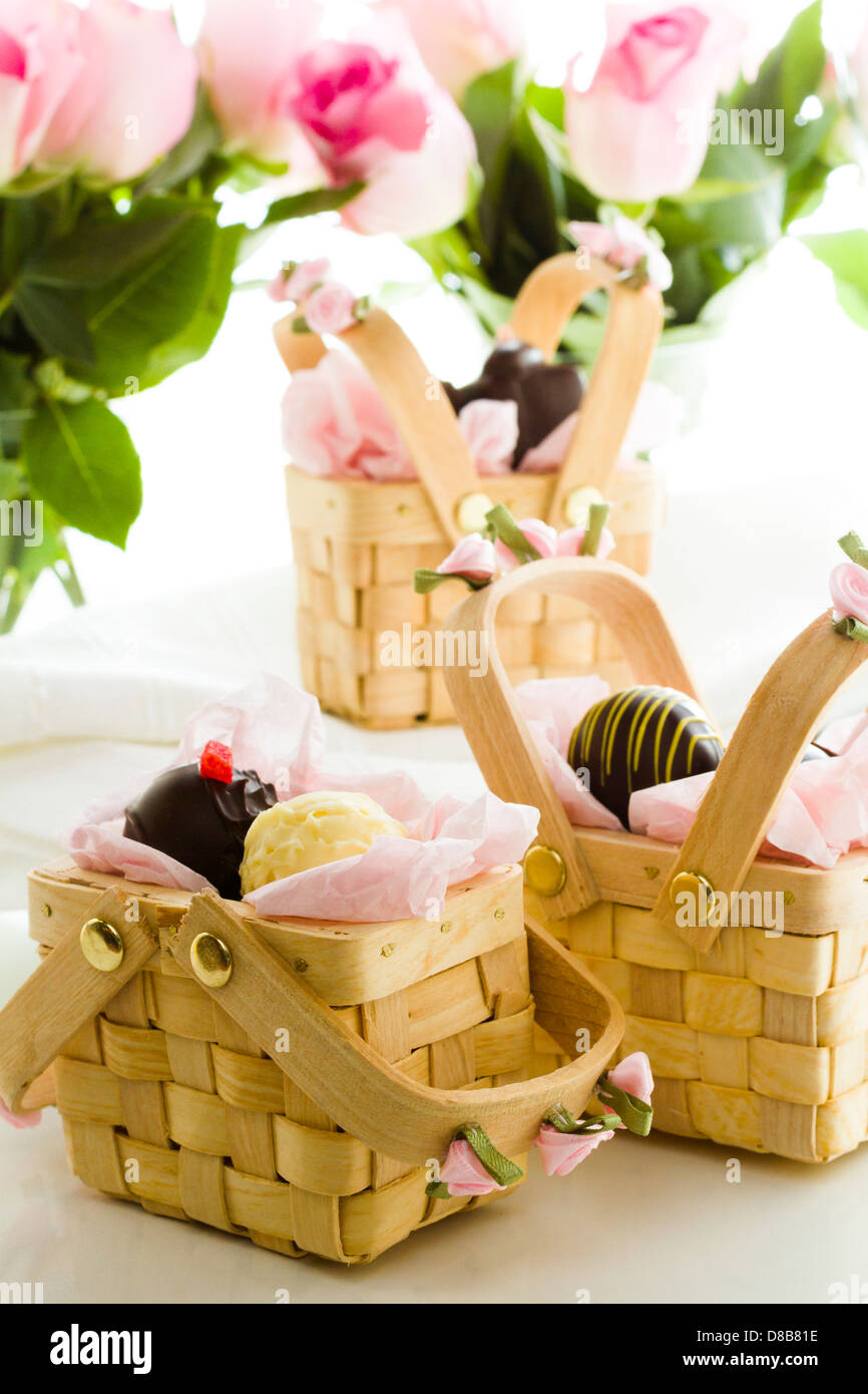 Miniature picnic baskets favor boxes filled with truffles Stock Photo