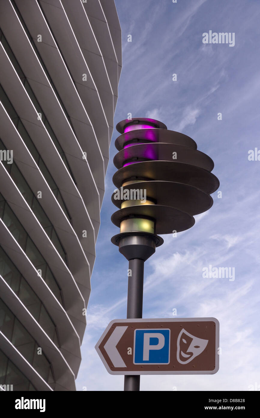 Parking direction sign and modern streetlight and front facade of the ...