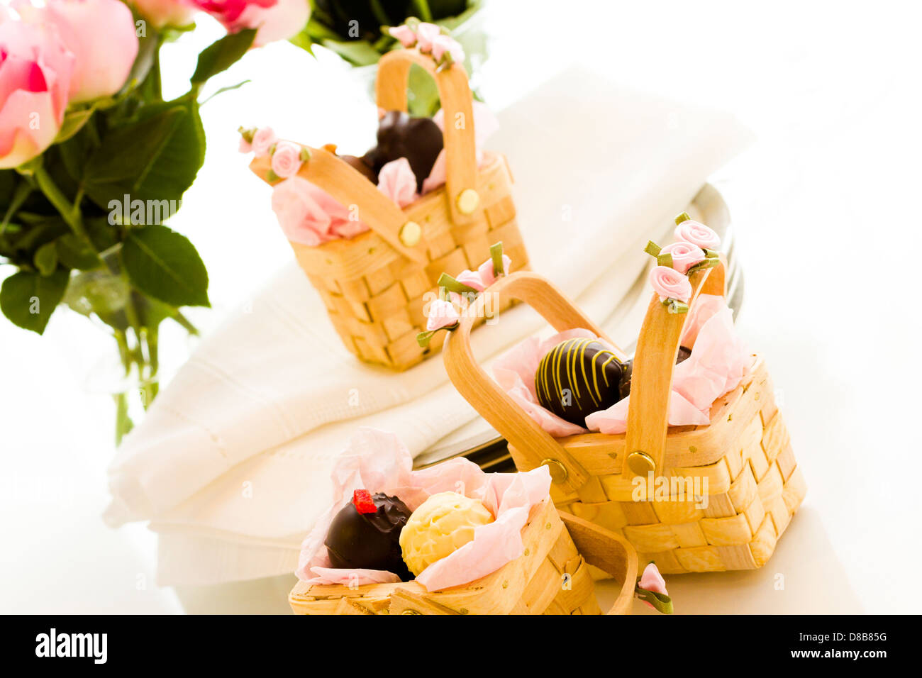 Miniature picnic baskets favor boxes filled with truffles Stock Photo