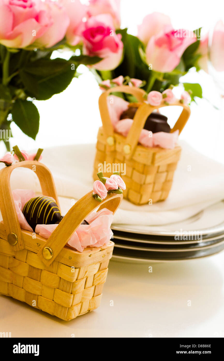Miniature picnic baskets favor boxes filled with truffles Stock Photo