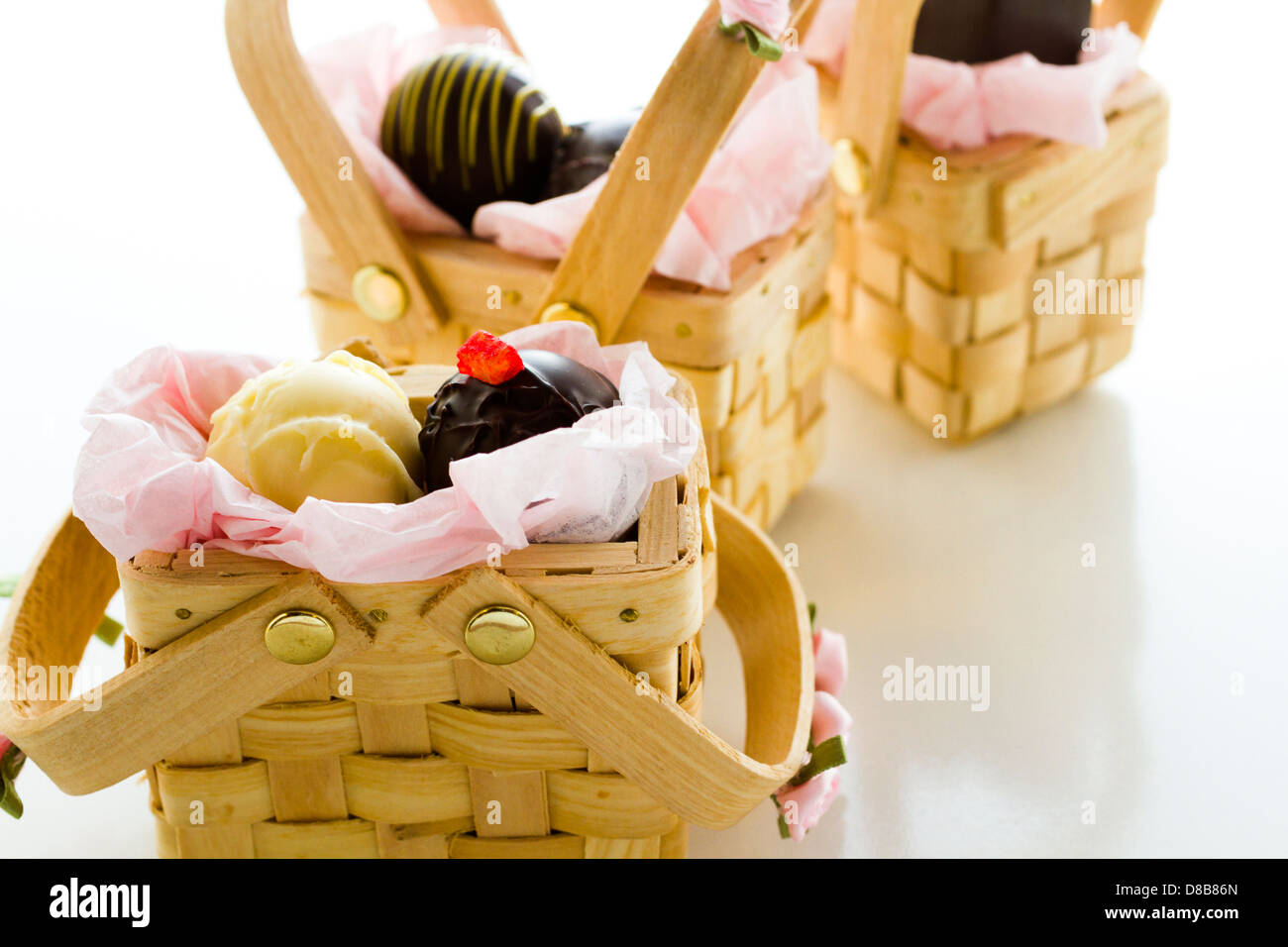 Miniature picnic baskets favor boxes filled with truffles Stock Photo