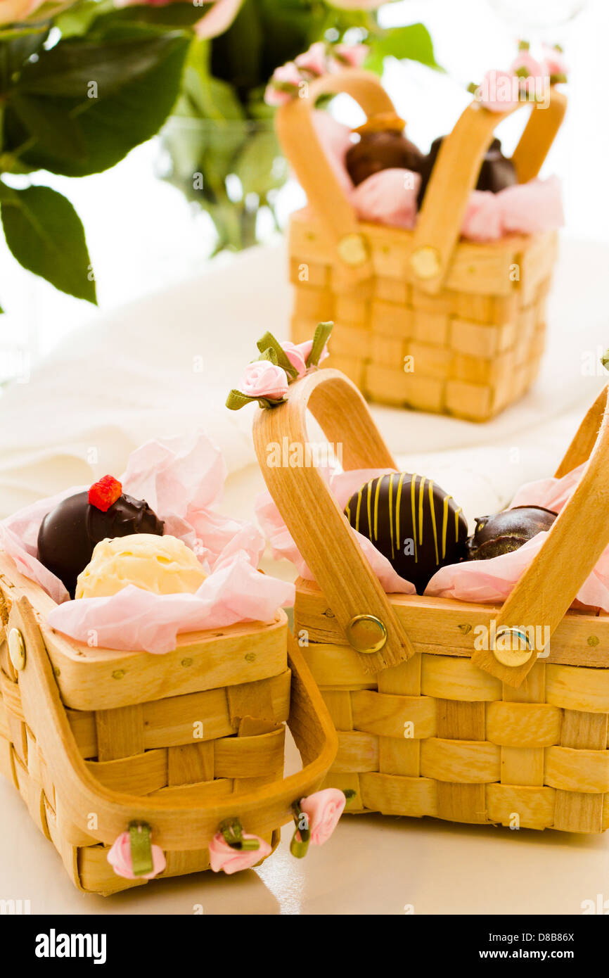 Miniature picnic baskets favor boxes filled with truffles Stock Photo