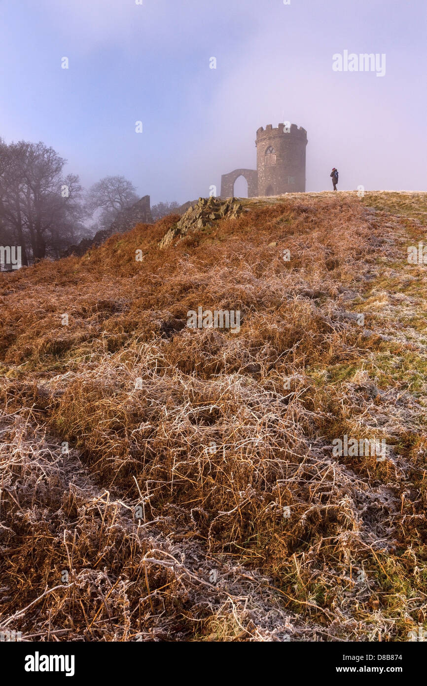 Lone figure by Old John folly on frosty morning with blue sky in Bradgate Park, Charnwood, Leicestershire, England, UK Stock Photo