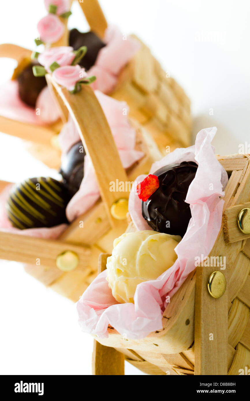 Miniature picnic baskets favor boxes filled with truffles Stock Photo