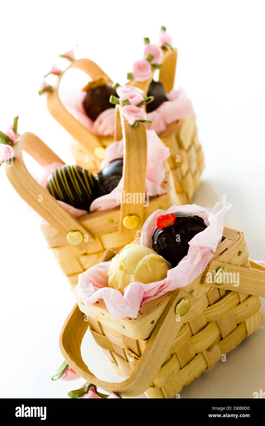 Miniature picnic baskets favor boxes filled with truffles Stock Photo