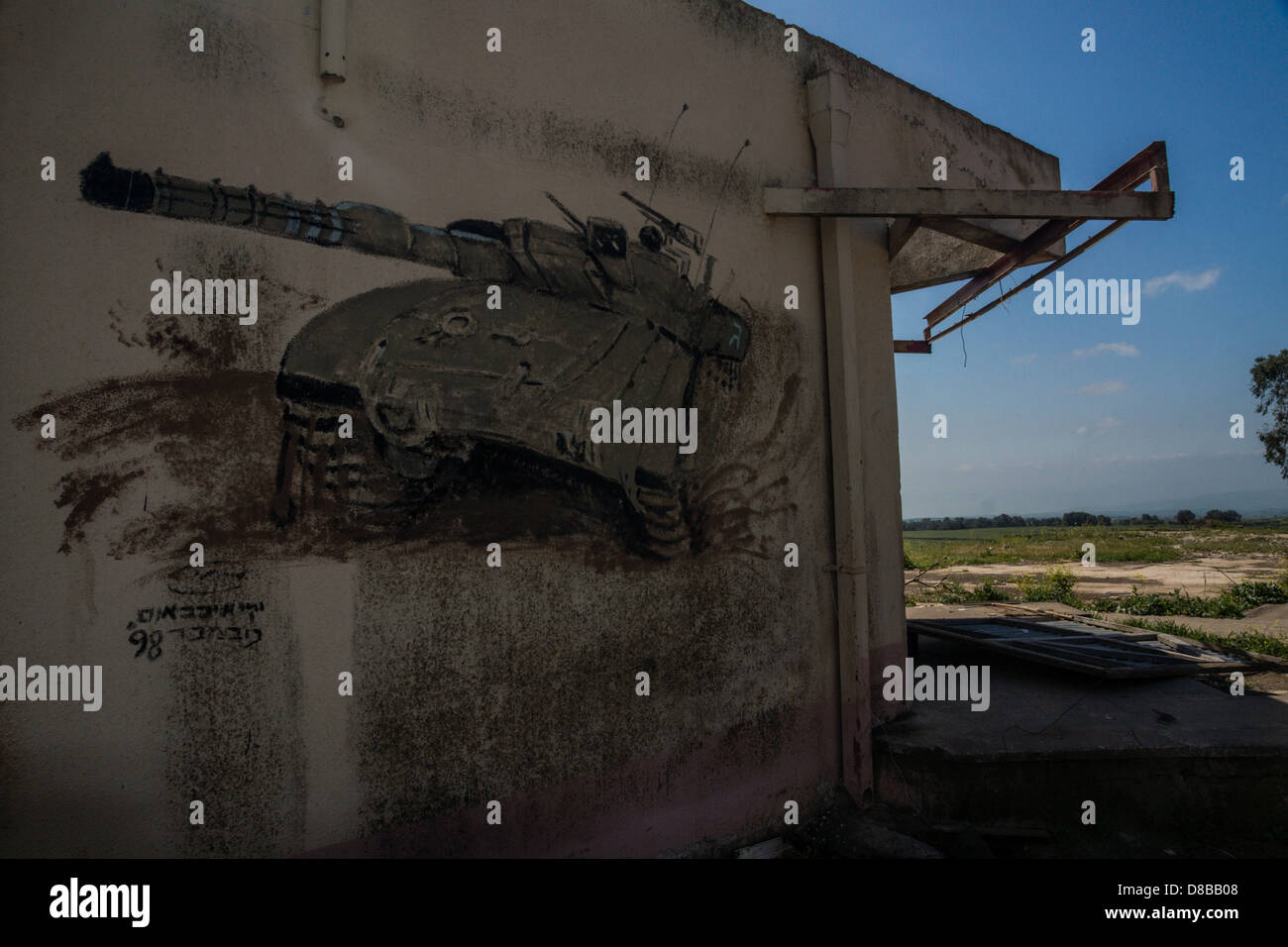 Golan Heights, Israel. A painting of a Israeli 'Merkava' tank on a building in an army training zone. Stock Photo