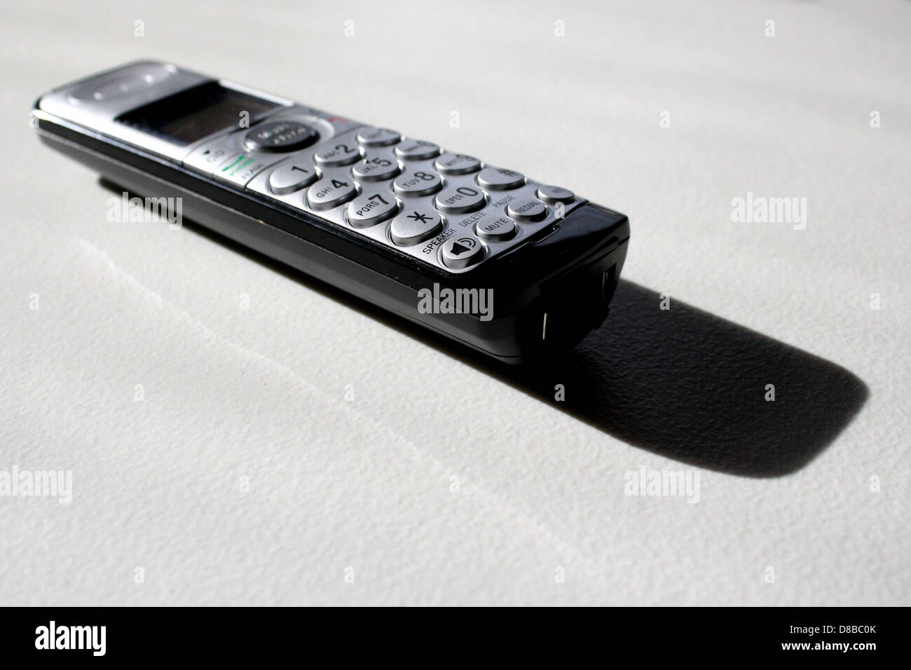 A cordless phone handset with a modern design, showing its buttons and ...