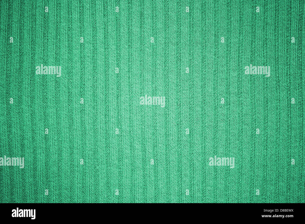 A close-up view of a green ribbed knit texture, showcasing the distinct ...