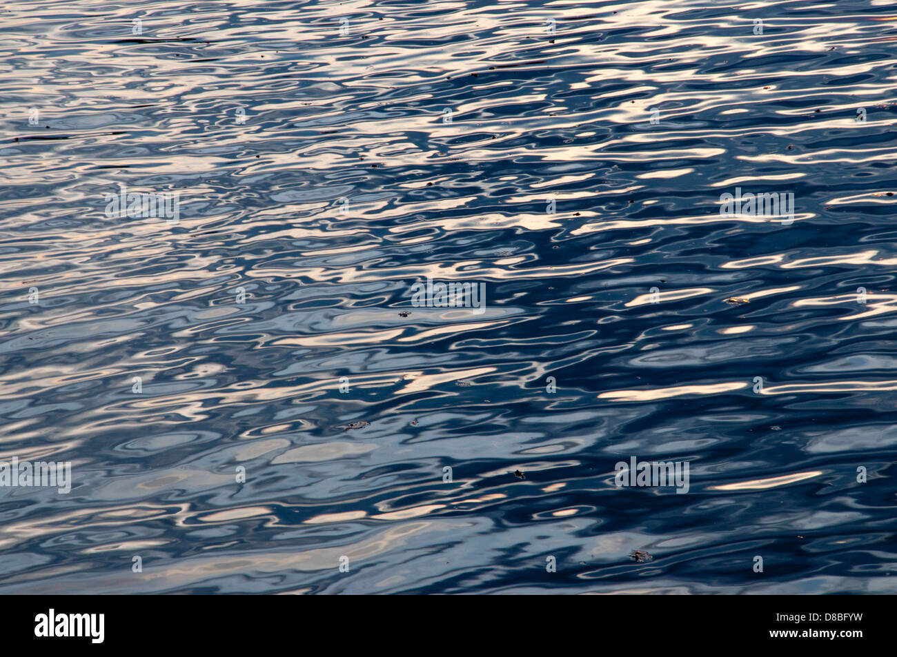 Reflections of dusk on waves. Stock Photo