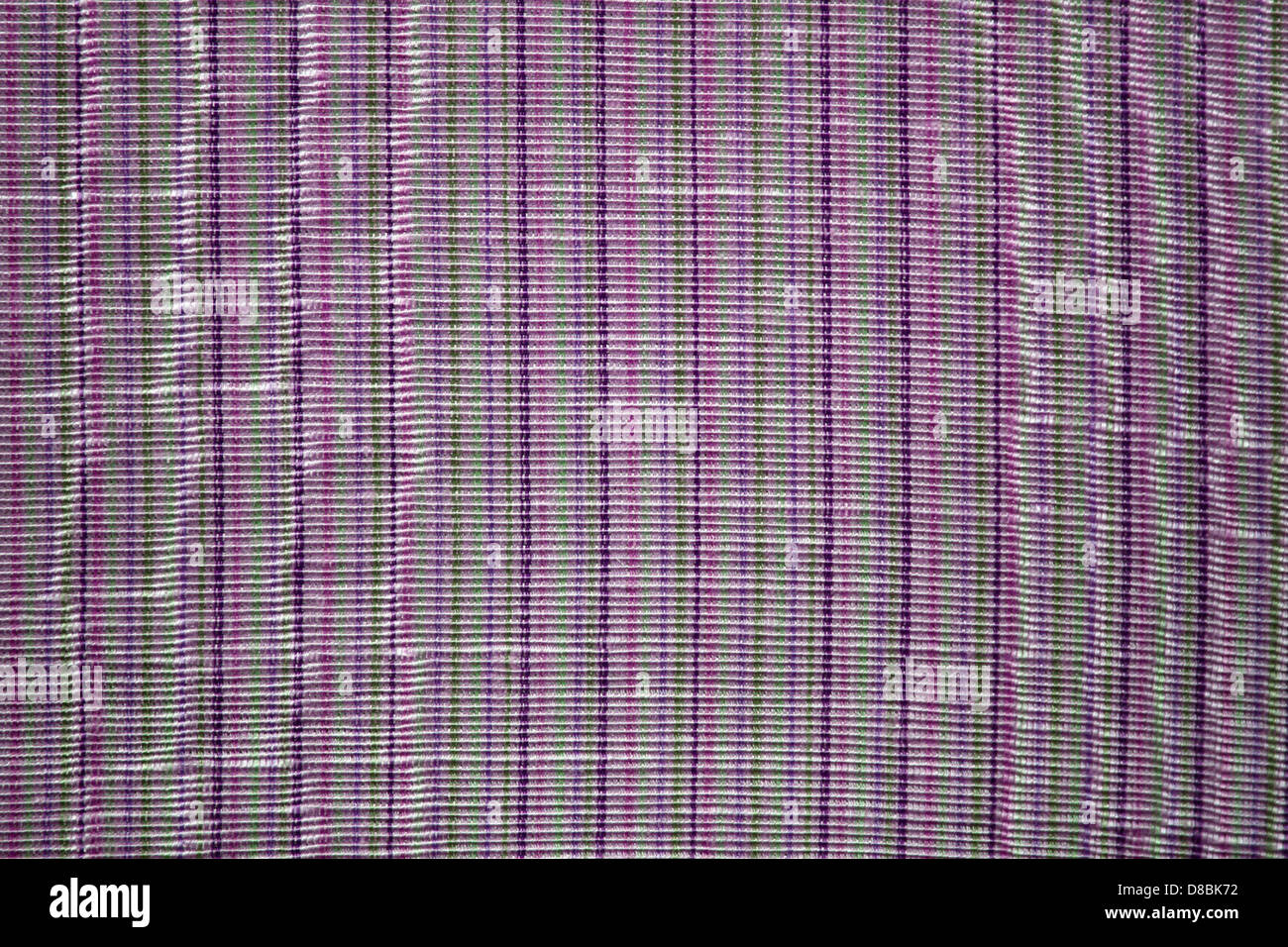 A close-up view of upholstery fabric featuring purple and green stripes ...