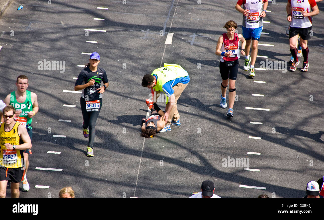 Runner collapses during 2013 London marathon on Victoria Embankment England Europe Stock Photo