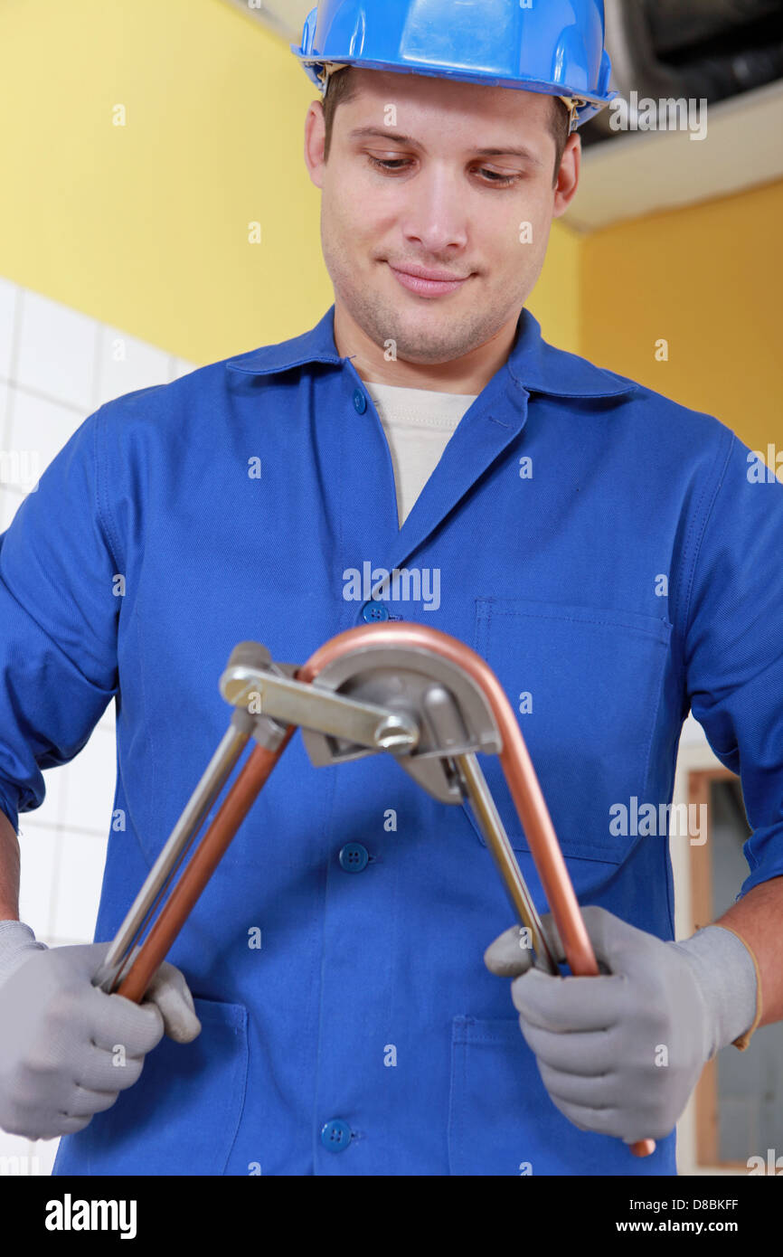 Laborer bending copper tube Stock Photo Alamy