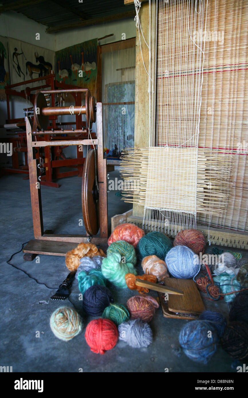 coloured balls of wool lie next to a weaving spin Stock Photo Alamy