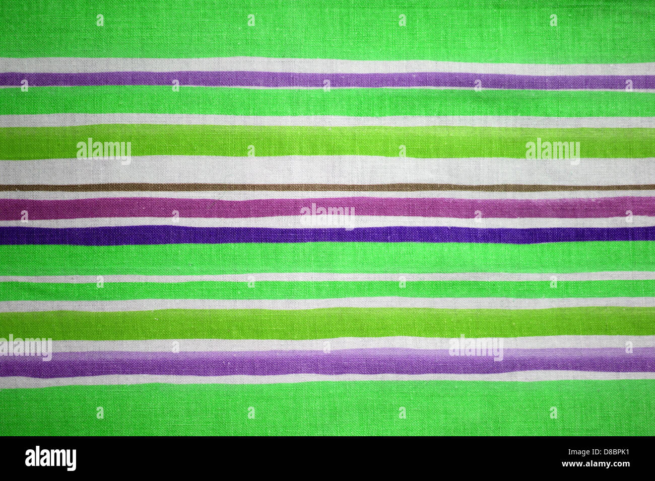A close-up view of fabric with green and purple stripes, showing a ...