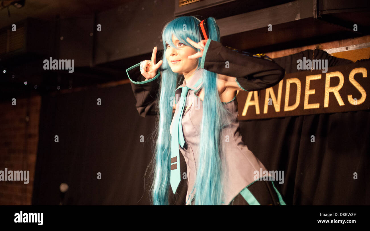 Young woman poses in cosplay / japanse/manga/ anime dress onstage in a Dr Sketchy life drawing event Stock Photo