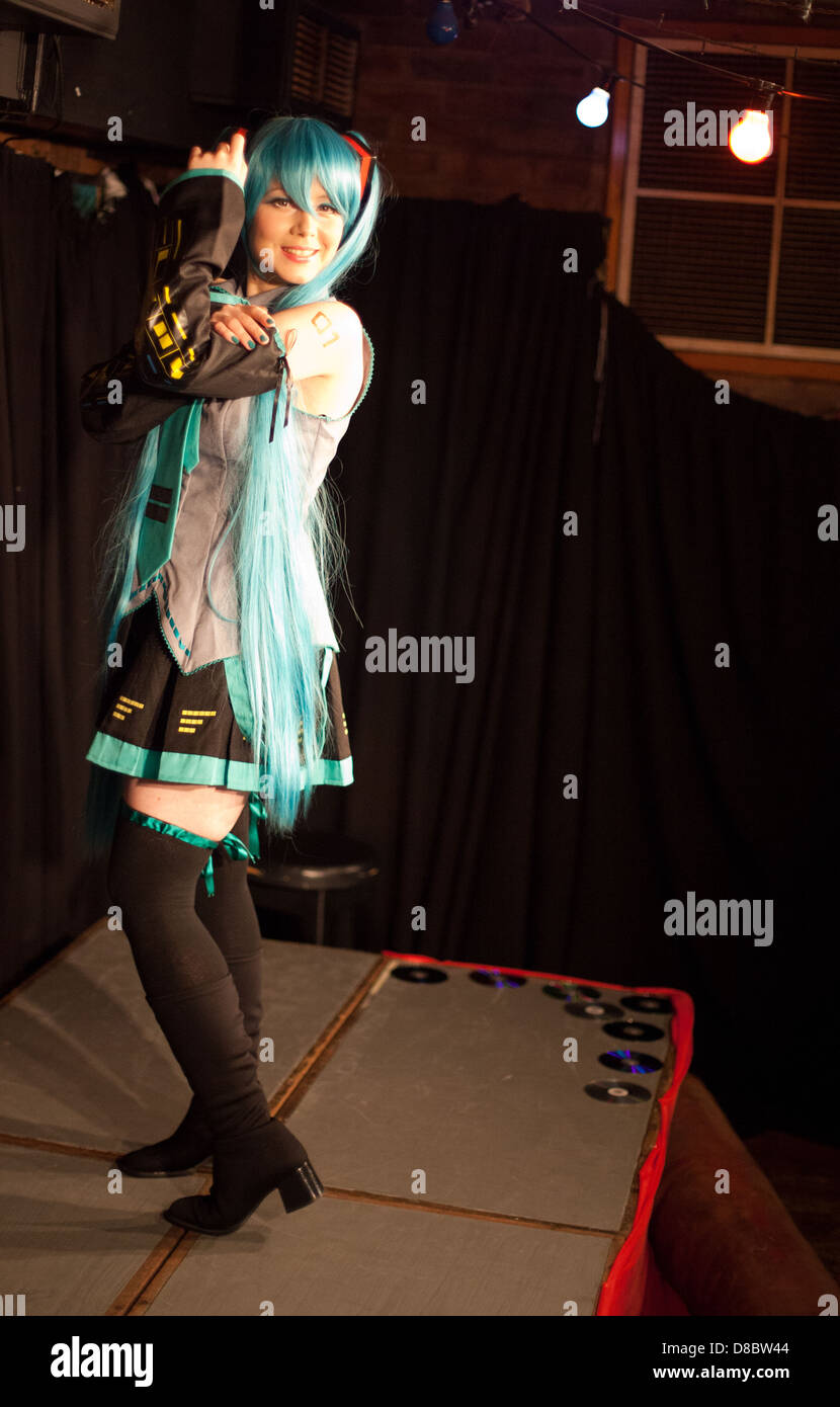Young woman poses in cosplay / japanse/manga/ anime dress onstage in a Dr Sketchy life drawing event Stock Photo