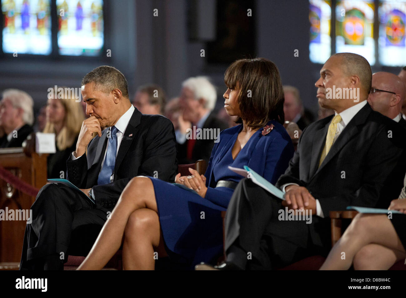 US President Barack Obama and First Lady Michelle Obama attend an interfaith prayer service dedicated to the victims of the Boston Marathon bombings at the Cathedral of the Holy Cross April 18, 2013 in Boston, MA. Massachusetts Governor Deval Patrick is seated at right. Stock Photo