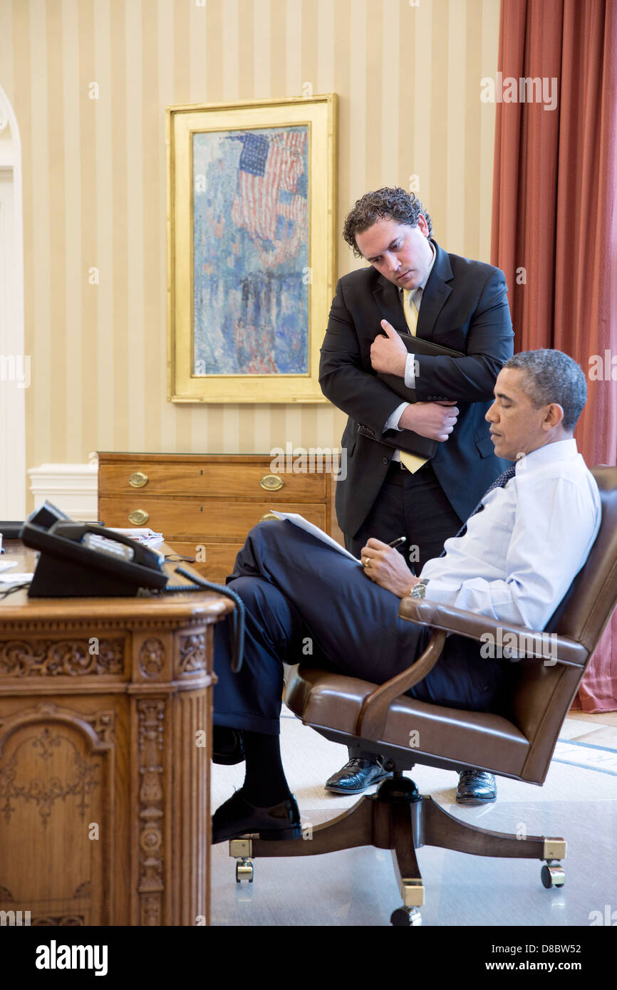 US President Barack Obama works with Cody Keenan, Director of Speechwriting, in the Oval Office April 17, 2013in Washington, DC. Stock Photo