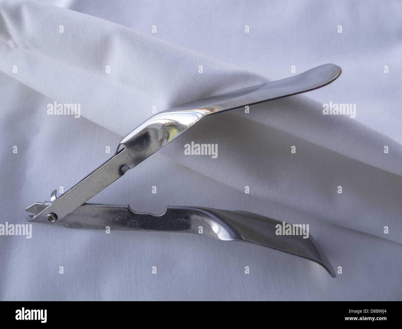 Surgical instrument for removing surgical clips from healed surgical incisions. Showing details if tines which grip the clips. Stock Photo