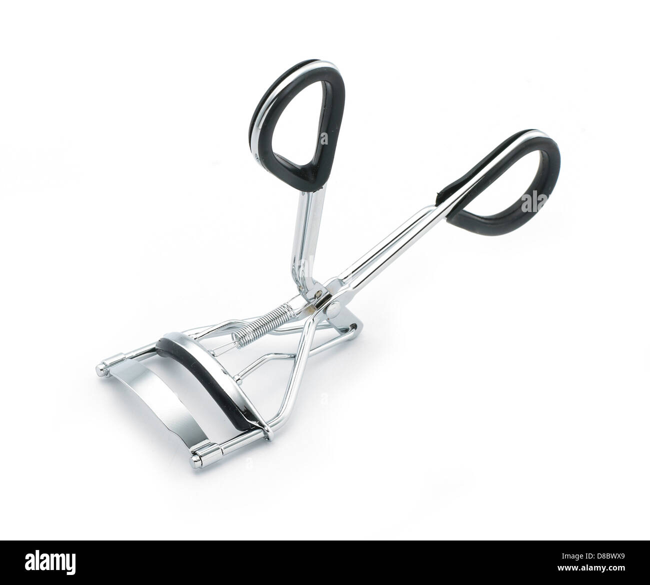 silver and black metal eyelash curlers cut out onto a white background Stock Photo