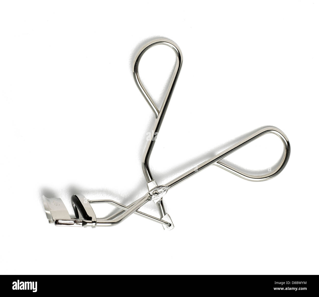 silver metal eyelash curlers cut out onto a white background Stock Photo