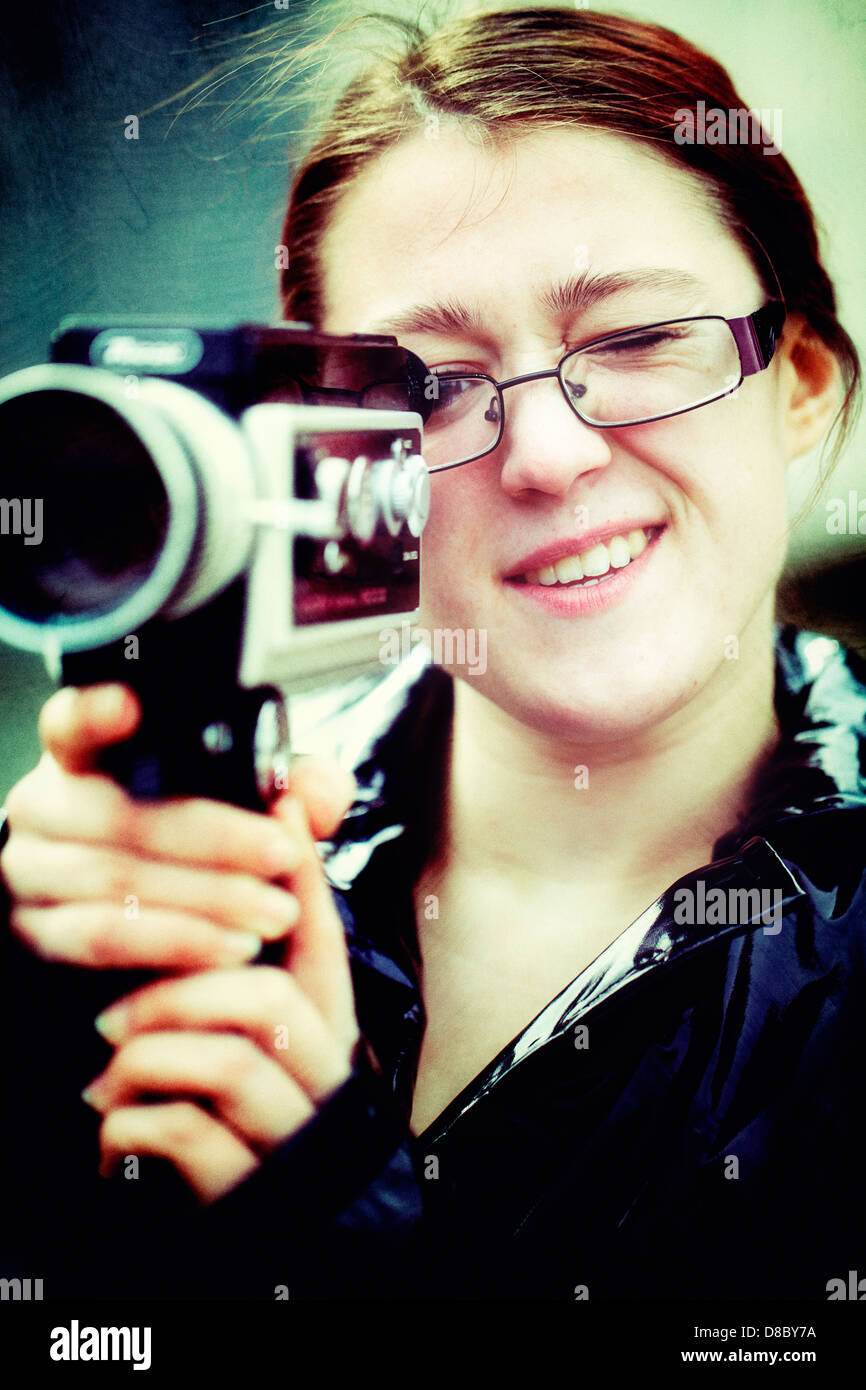 Young woman using a vintage super 8 cine camera Stock Photo