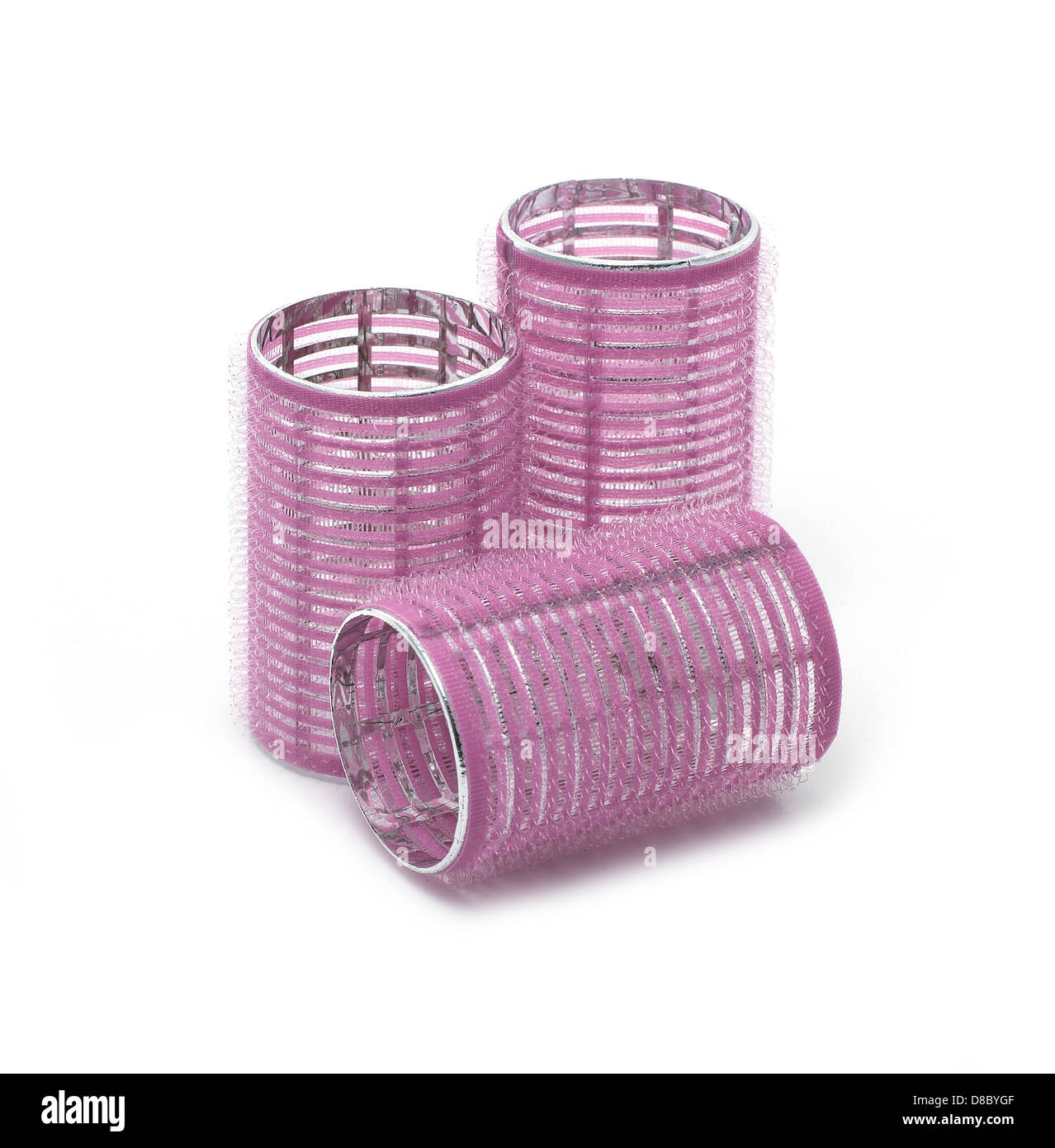 purple hair rollers cut out onto a white background Stock Photo