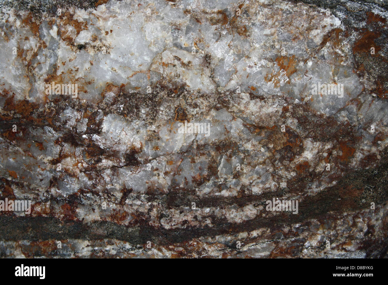 white quartz rock texture with hematite iron rust stains Stock Photo